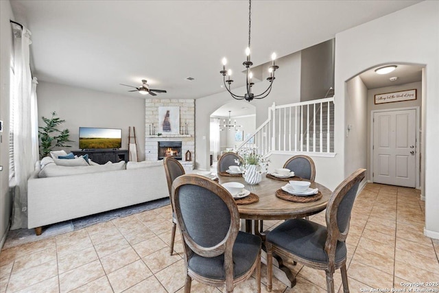 25702 Coleus, San Antonio, TX 78261 - dining room featuring a chandelier, a fireplace, ceiling fan, stairs, and arched walkways