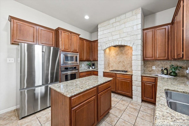 25702 Coleus, San Antonio, TX 78261 - kitchen featuring stainless steel appliances, light tile patterned floors, tasteful backsplash, light stone countertops, and a kitchen island