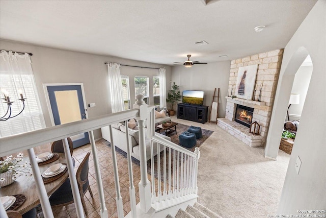 25702 Coleus, San Antonio, TX 78261 - carpeted living room with a fireplace, arched walkways, and a ceiling fan