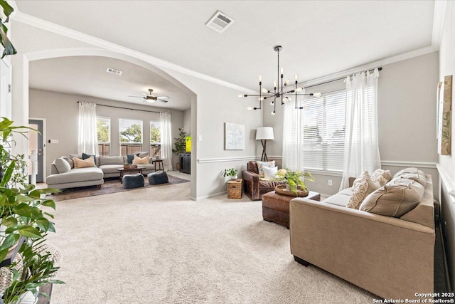 25702 Coleus, San Antonio, TX 78261 - carpeted living room with arched walkways, ornamental molding, a chandelier, and ceiling fan