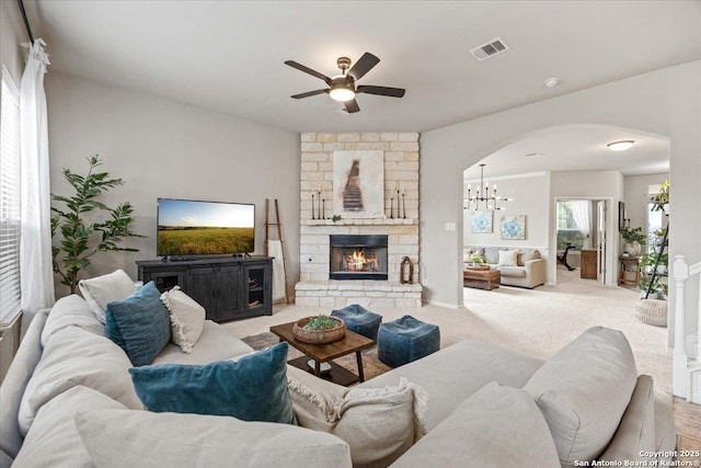 25702 Coleus, San Antonio, TX 78261 - living area featuring arched walkways, ceiling fan, a fireplace, carpet, and a chandelier