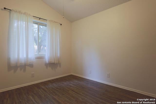 9218 Woodheather, San Antonio, TX 78254 - empty room with lofted ceiling and dark wood-style floors