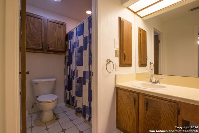 9218 Woodheather, San Antonio, TX 78254 - full bath featuring vanity and a shower with shower curtain