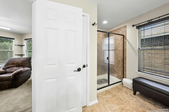 20630 Creek Riv, San Antonio, TX 78259 - full bath with a stall shower, tile patterned floors, and a textured ceiling