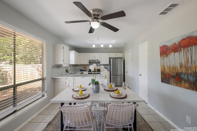 3719 Pipers Rdg, San Antonio, TX 78251 - kitchen featuring freestanding refrigerator, light tile patterned floors, and plenty of natural light