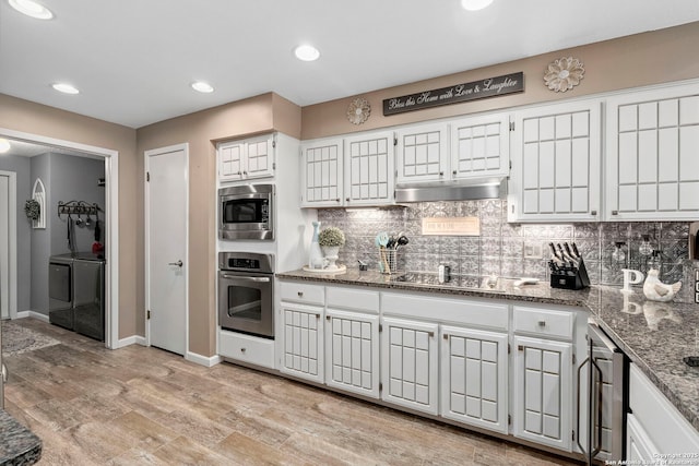 2026 Encino Vista St, San Antonio, TX 78259 - kitchen with stainless steel appliances, washer and clothes dryer, under cabinet range hood, decorative backsplash, and light wood-style floors