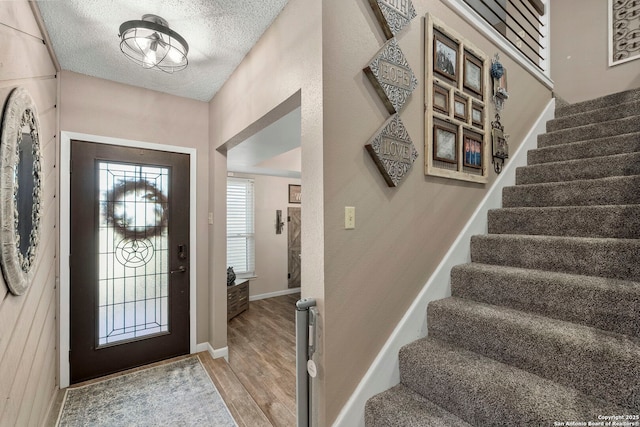 2026 Encino Vista St, San Antonio, TX 78259 - foyer entrance with stairs, light wood-style flooring, and a textured ceiling