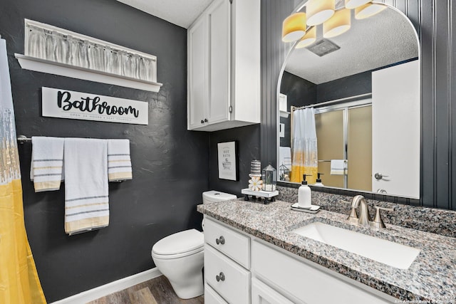 2026 Encino Vista St, San Antonio, TX 78259 - bathroom with wood finished floors, vanity, a shower with curtain, and a textured ceiling