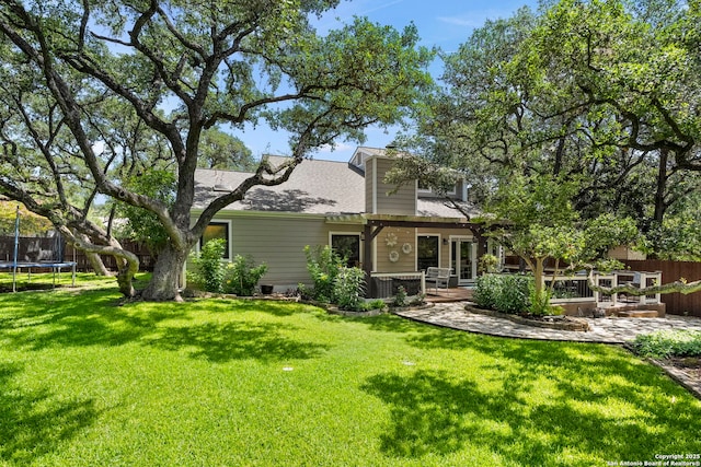 2026 Encino Vista St, San Antonio, TX 78259 - rear view of house featuring a trampoline, roof with shingles, and a deck