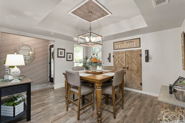 2026 Encino Vista St, San Antonio, TX 78259 - dining space featuring a tray ceiling, a chandelier, and wood finished floors