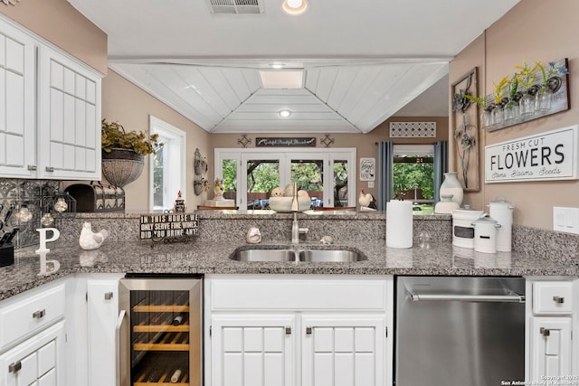 2026 Encino Vista St, San Antonio, TX 78259 - kitchen with stainless steel dishwasher, beverage cooler, white cabinetry, and stone counters