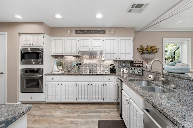 2026 Encino Vista St, San Antonio, TX 78259 - kitchen featuring stainless steel appliances, dark stone countertops, tasteful backsplash, white cabinets, and recessed lighting