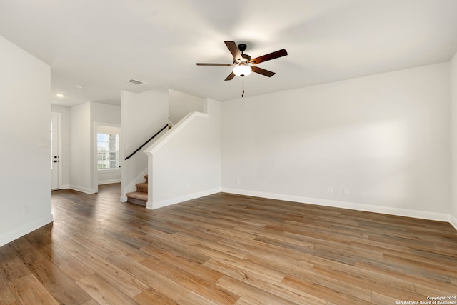 6509 Titan Park, Converse, TX 78109 - unfurnished living room with a ceiling fan, stairs, wood finished floors, and recessed lighting