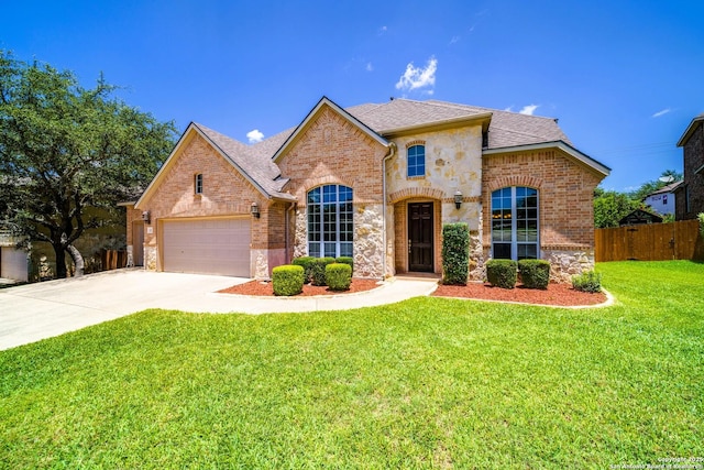 139 Sable Hts, San Antonio, TX 78258 - french country inspired facade with brick siding, an attached garage, stone siding, and concrete driveway