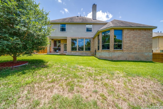 139 Sable Hts, San Antonio, TX 78258 - back of house featuring brick siding, a lawn, and a chimney