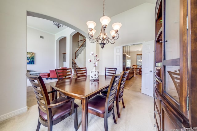 139 Sable Hts, San Antonio, TX 78258 - dining space with a chandelier, arched walkways, light carpet, stairway, and crown molding