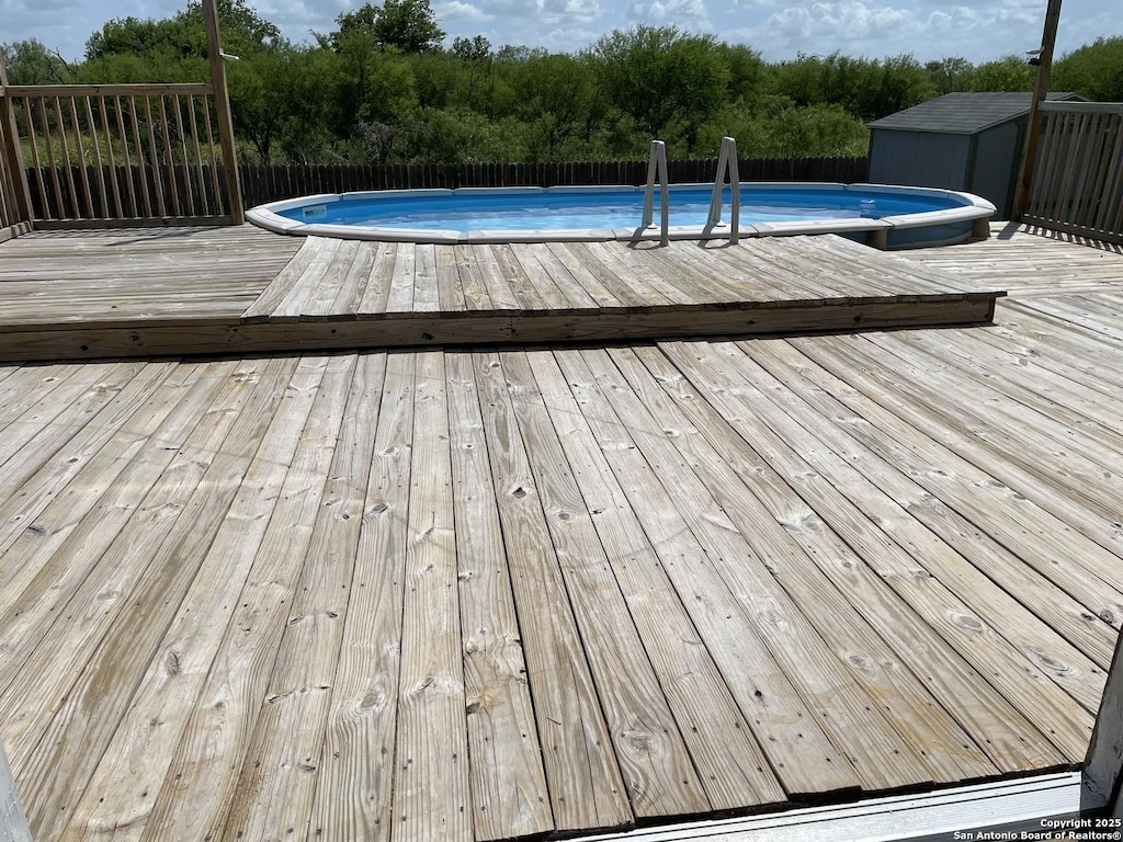 213 Hinge Loop, Cibolo, TX 78108 - view of pool with a deck, a storage shed, and view of wooded area