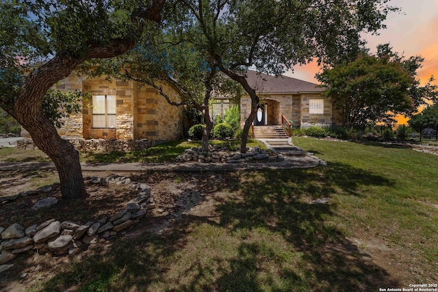 345 Blackbird, Spring Branch, TX 78070 - view of property hidden behind natural elements featuring stone siding and a lawn