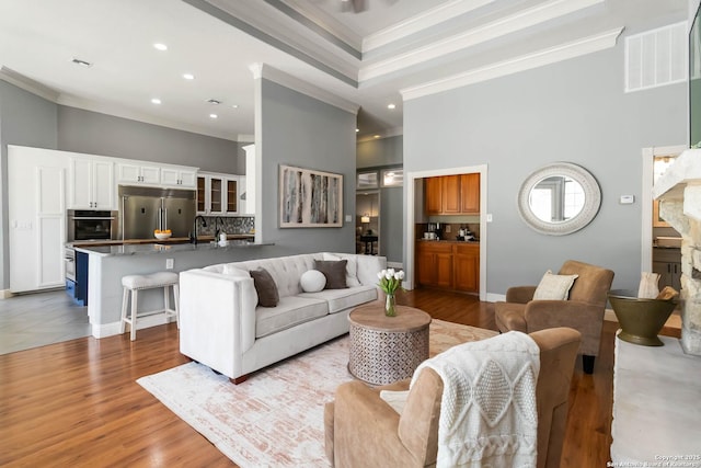 345 Blackbird, Spring Branch, TX 78070 - living room featuring ornamental molding, a towering ceiling, recessed lighting, and wood finished floors