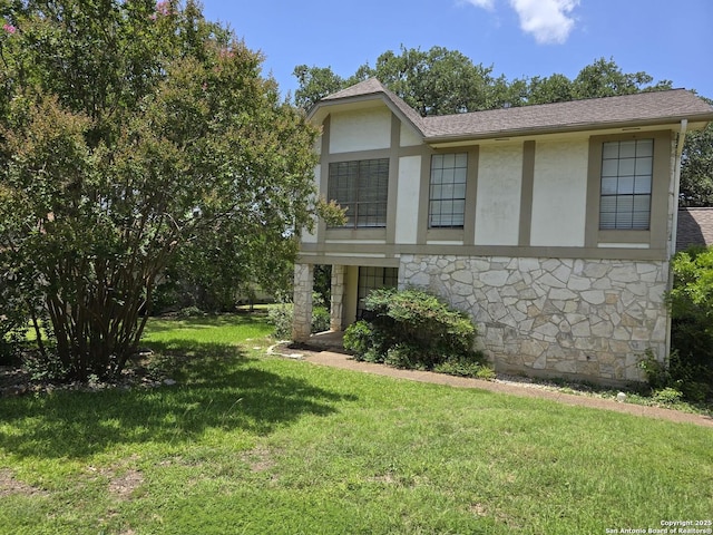 14107 Moss Farm, San Antonio, TX 78231 - view of front of house with stucco siding, stone siding, a front yard, and a shingled roof