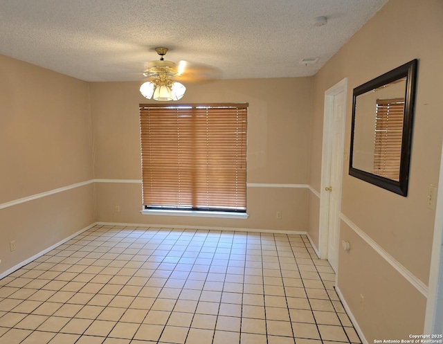 14107 Moss Farm, San Antonio, TX 78231 - spare room featuring ceiling fan, a textured ceiling, light tile patterned floors, and a smoke detector