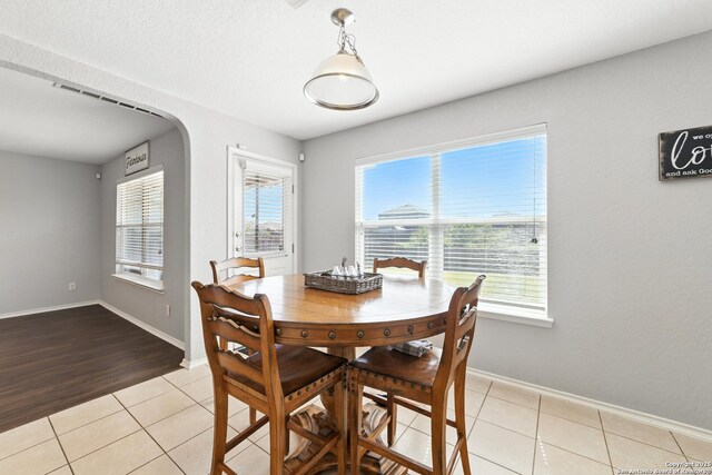 811 Cormorant, San Antonio, TX 78245 - dining space featuring healthy amount of natural light, light tile patterned floors, and arched walkways