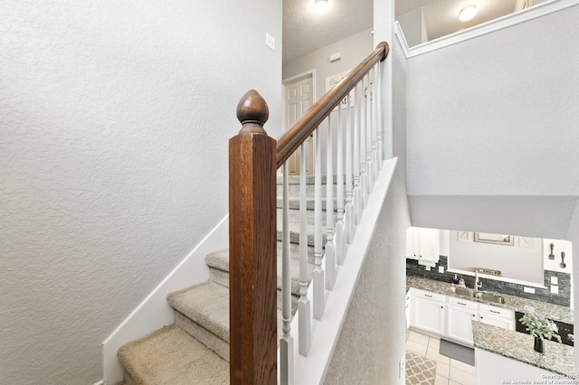 811 Cormorant, San Antonio, TX 78245 - stairway with tile patterned flooring and a textured wall