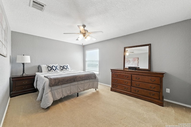 811 Cormorant, San Antonio, TX 78245 - bedroom featuring light colored carpet, ceiling fan, and a textured ceiling