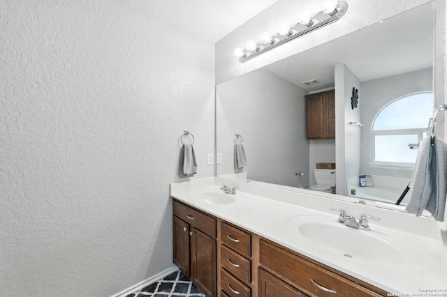 811 Cormorant, San Antonio, TX 78245 - bathroom featuring a textured wall, double vanity, and a garden tub