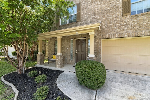 811 Cormorant, San Antonio, TX 78245 - property entrance featuring brick siding, covered porch, and an attached garage