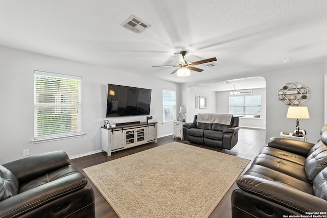 811 Cormorant, San Antonio, TX 78245 - living room with healthy amount of natural light, ceiling fan, dark wood-type flooring, and a chandelier