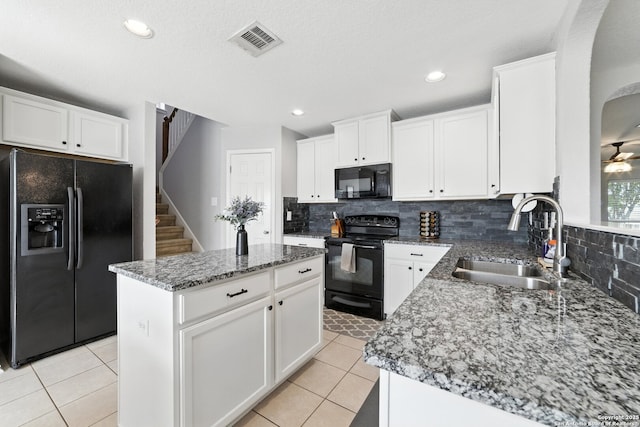 811 Cormorant, San Antonio, TX 78245 - kitchen featuring black appliances, backsplash, stone countertops, light tile patterned floors, and recessed lighting
