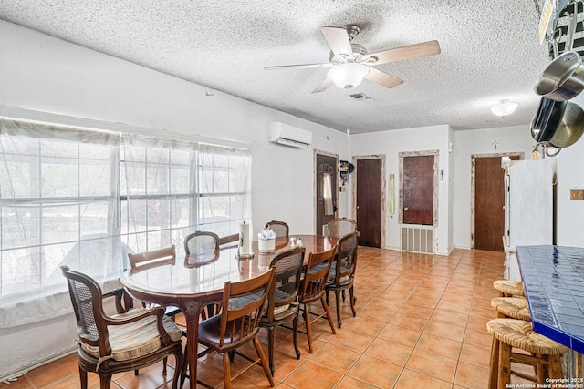 114 Pace Miller, Del Rio, TX 78840 - dining area featuring a wall unit AC, ceiling fan, a textured ceiling, and light tile patterned floors