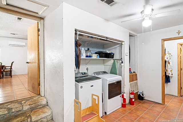 114 Pace Miller, Del Rio, TX 78840 - laundry area with separate washer and dryer, an AC wall unit, light tile patterned floors, ceiling fan, and a textured ceiling