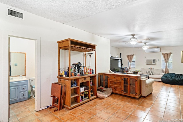 114 Pace Miller, Del Rio, TX 78840 - kitchen with a wall mounted air conditioner, light tile patterned floors, a ceiling fan, a textured ceiling, and open floor plan