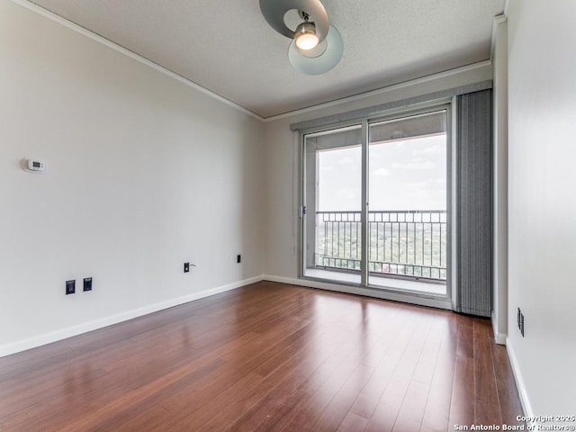 1 Towers Park Unit 1803, San Antonio, TX 78209 - spare room featuring crown molding, dark wood-type flooring, and a ceiling fan