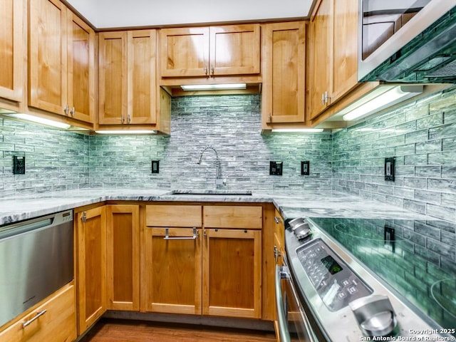 1 Towers Park Unit 1803, San Antonio, TX 78209 - kitchen featuring appliances with stainless steel finishes, light stone countertops, backsplash, and brown cabinets