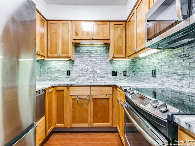1 Towers Park Unit 1803, San Antonio, TX 78209 - kitchen with stainless steel appliances, light stone counters, tasteful backsplash, and light wood-style flooring