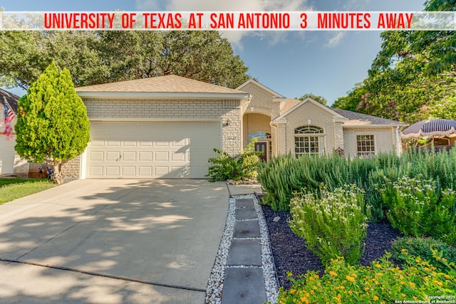 13947 Amber Crst, San Antonio, TX 78249 - view of front of home with an attached garage, brick siding, and concrete driveway
