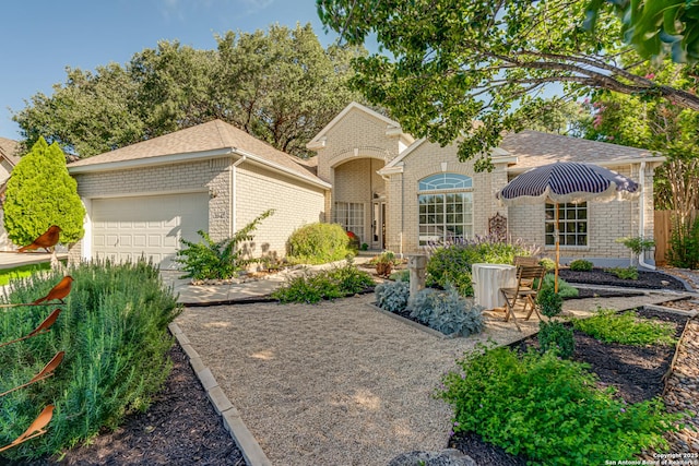 13947 Amber Crst, San Antonio, TX 78249 - view of front of home featuring brick siding, an attached garage, and a shingled roof