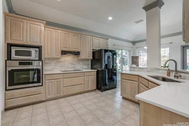 13947 Amber Crst, San Antonio, TX 78249 - kitchen featuring black appliances, light brown cabinetry, vaulted ceiling, light countertops, and decorative backsplash