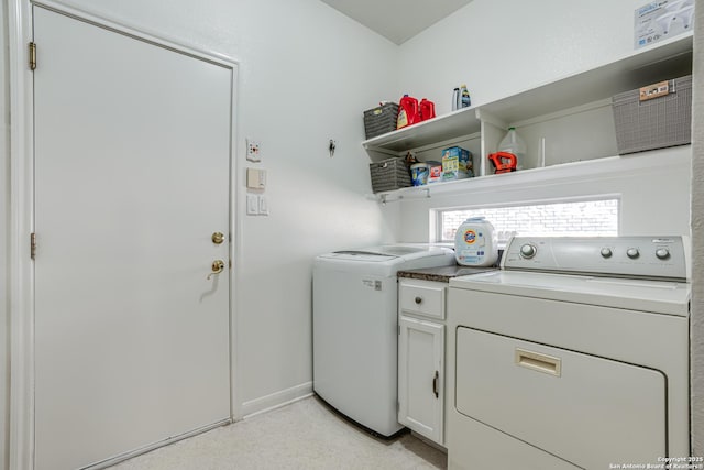 13947 Amber Crst, San Antonio, TX 78249 - washroom featuring washing machine and clothes dryer and cabinet space