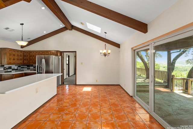 25615 Dull Knife Trl, San Antonio, TX 78255 - kitchen with stainless steel fridge with ice dispenser, light countertops, a chandelier, decorative light fixtures, and brown cabinetry