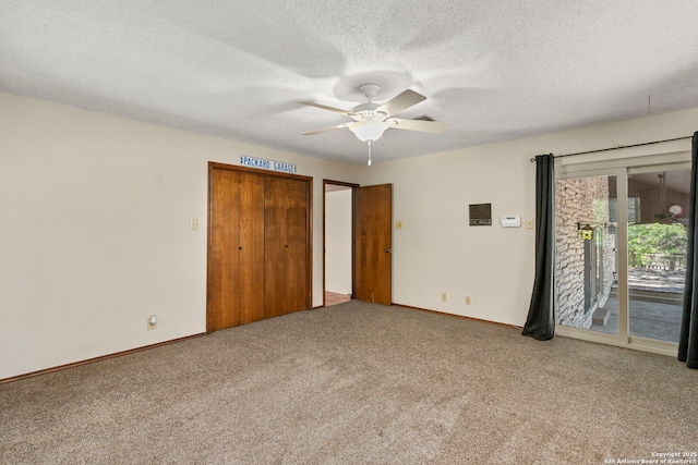 25615 Dull Knife Trl, San Antonio, TX 78255 - unfurnished bedroom featuring access to exterior, carpet floors, a textured ceiling, and a ceiling fan