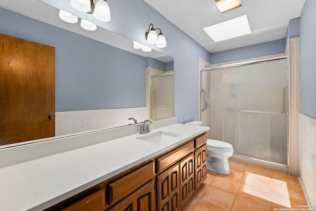 25615 Dull Knife Trl, San Antonio, TX 78255 - bathroom featuring vanity, a skylight, a stall shower, and tile patterned flooring