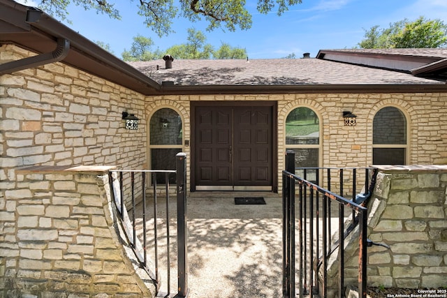 25615 Dull Knife Trl, San Antonio, TX 78255 - property entrance featuring a shingled roof, stone siding, and an attached garage