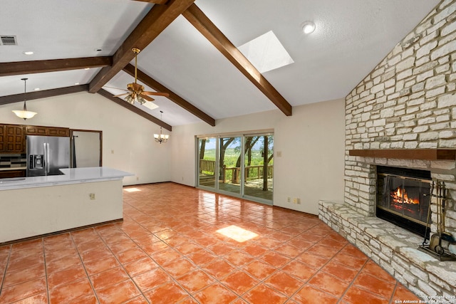 25615 Dull Knife Trl, San Antonio, TX 78255 - unfurnished living room with a stone fireplace, a skylight, ceiling fan, light tile patterned flooring, and recessed lighting