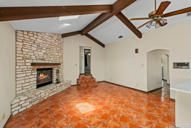 25615 Dull Knife Trl, San Antonio, TX 78255 - unfurnished living room featuring a ceiling fan, arched walkways, a fireplace, and tile patterned flooring