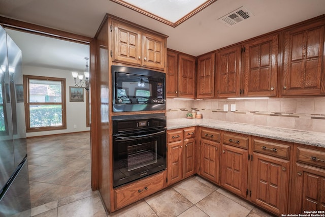 14519 Parksite Woods, San Antonio, TX 78249 - kitchen featuring black appliances, backsplash, a chandelier, and light stone countertops