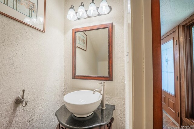 14519 Parksite Woods, San Antonio, TX 78249 - bathroom featuring a textured wall and vanity